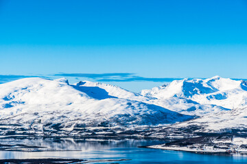 View from Mount Storsteinen on the Norwegian mountains around the city of Tromso