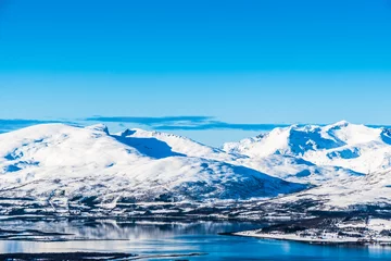 Fototapeten View from Mount Storsteinen on the Norwegian mountains around the city of Tromso © Daniela Baumann