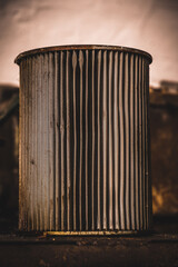 Old oil filter on a shelf, vertical