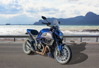 Fototapeta na wymiar Motorcycle on the road near the seashore