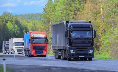 Convoy of Trucks Moves on Road - 542487885
