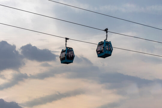 Two cablebus or teleferico cabins in Mexico City with the sky in the background