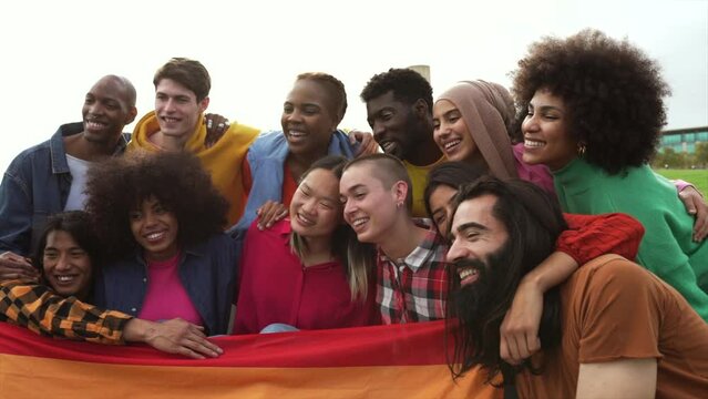 Diverse young multiracial friends celebrating gay pride festival - LGBTQ community concept.