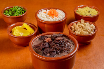 Brazilian feijoada. Food made with black beans, pork and sausage, with traditional side dishes