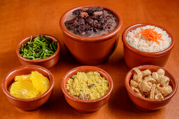 Brazilian feijoada. Food made with black beans, pork and sausage, with traditional side dishes