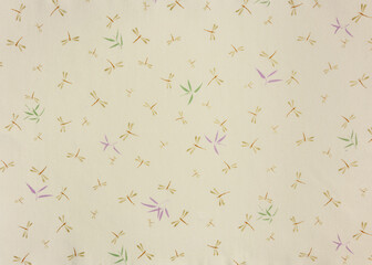 Close up on a high detailed photograph of a Japanese furoshiki cloth with a pattern design illustrated by odonata dragonflies and damselflies insects and broad-leaf bamboo or sasa bamboo leaves.