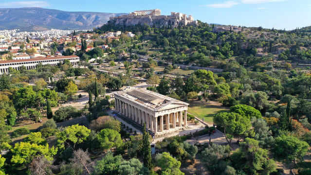 Aerial drone photo of iconic Temple of Hephaestus one of the most well preserved in Greece and Acropolis hill at the background, Athens historic centre, Attica, Greece