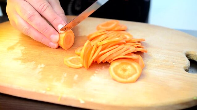Cutting of carrots. The cook cuts carrots