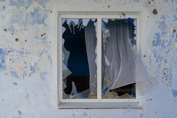 War in Ukraine. 2022 Russian invasion of Ukraine. Window of a house damaged by shelling (close-up)....