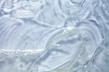 Obraz na płótnie Canvas Liquid gray cosmetic smudge cream gel background 