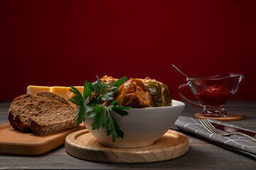 stuffed bell peppers with cheese and sliced bread on a red background
