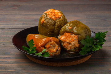 stuffed bell peppers on a plate on a wooden background