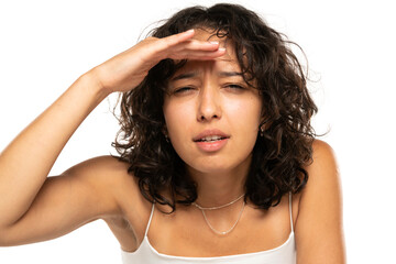 Fototapeta premium Portrait of dark skinned etnic woman with bad sight on white background