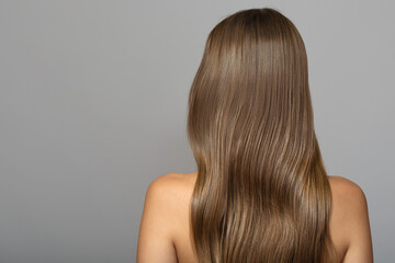 wavy  brown hair back view. Grey background