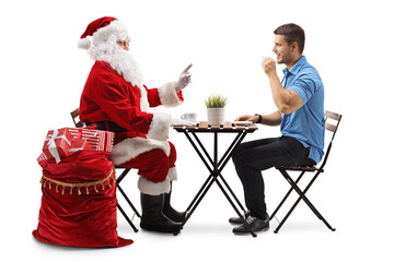 Santa Claus talking to a young man in a cafe