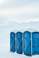Portable blue toilets for skiers ski resort clients on top of mountain in Gudauri winter ski resort