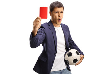 Casual young man holding a football and showing a red card