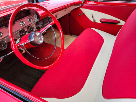 Bright Red And White Vintage Car Interior With Bench Seat And Steering Wheel