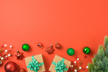 Christmas and New Year greeting card with gift box, ornaments and decorations on red background.  Top view, flat lay