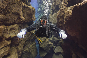 Experience drysuit diving or snorkeling in Silfra crystal clear water. Iceland scuba diving.