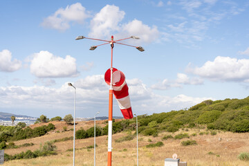 Wind sock fly. Summer hot day on private sporty airport with abandoned windsock, wind is blowing...