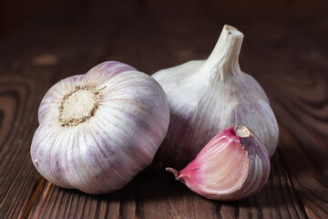Garlic cloves on wooden table. Fresh peeled garlics and bulbs.