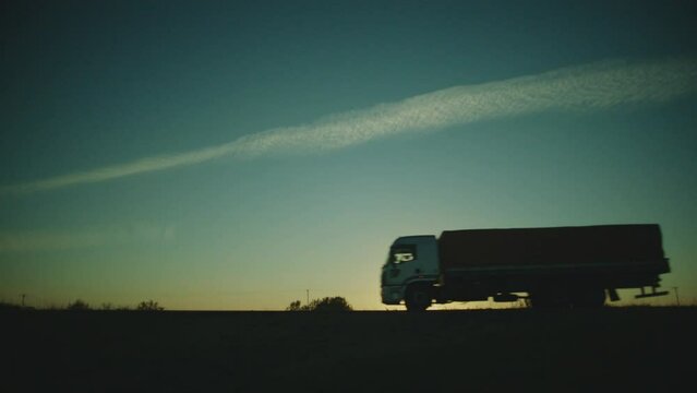 establishing side shot of the road with a truck and a car passing by at brazil
