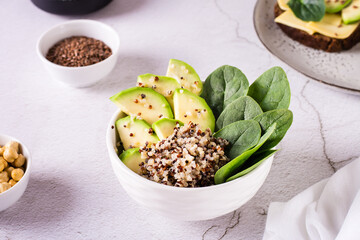 Homemade bowl with avocado, quinoa and spinach on the table. Healthy vitamin nutrition