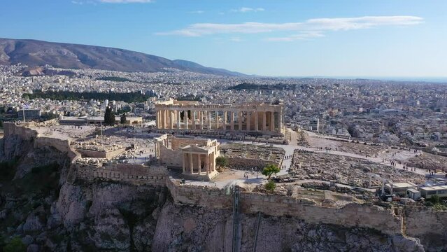 Aerial drone cinematic video of iconic Acropolis hill and the Parthenon a Unesco World Heritage Masterpiece of ancient times, Athens historic centre, Attica, Greece