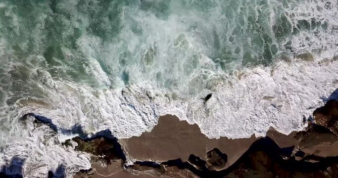 Waves splashing and crashing at the tide pools on a sunny morning
