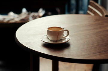 Coffee on the woody table. Espresso. Empty cup