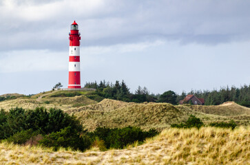 Fototapeta na wymiar Amrum lighthouse. Amrum is one of the North Frisian Islands on the German North Sea coast, south of Sylt and west of Foehr