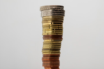 High stack of euro coins stacked on top of each other from smaller to larger. The concept of...