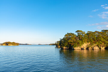 Fototapeta na wymiar Matsushima Bay in dusk, beautiful islands covered with pine trees and rocks. One of the Three Views of Japan, and is also the site of the Zuigan-ji, Entsu-in and Kanrantei. in Miyagi Prefecture, Japan