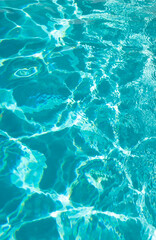Fototapeta na wymiar blue color background of swimming pool water with ripples in mediterranean
