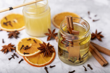 The process of making homemade candles on the table. Close-up. Pouring molten wax. Soy candles handmade with wooden wicks. Vegan product without cruelty to animals.Decor.