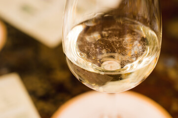 Close-up of white sparkling wine in a glass goblet. Wine degustation