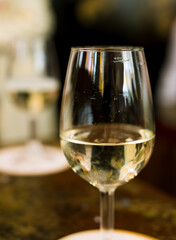 Close-up of white sparkling wine in a glass goblet. Wine degustation