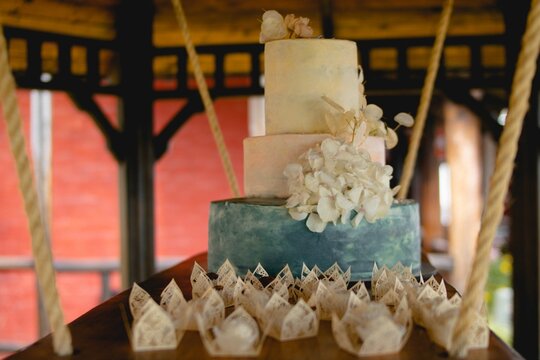 Wedding Cake On A Floating Board Secured With Ropes In A Wooden Building