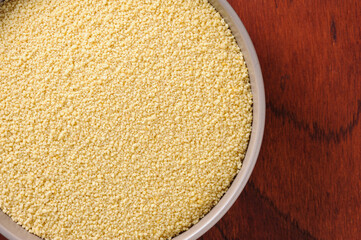 Couscous beans in rustic bowl and wooden background. Top view. Space for text.