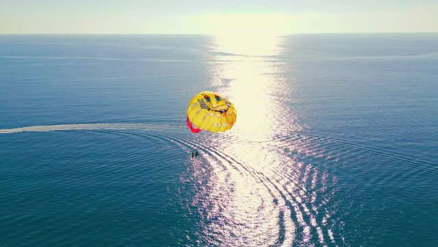 stunning view of colorful parasail wing flying over the bright blue sea, Alanya, Turkey. High quality 4k footage