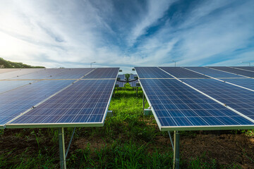 Photovoltaic solar power panel on dramatic sunset blue sky background, green clean Alternative power energy concept.