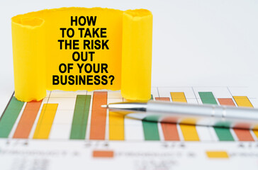 On the business charts are a pen and a paper plate with the inscription - How To Take the Risk Out...