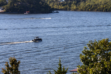 pontoon boat with canopy on lake