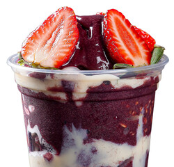 Brazilian frozen açaí in a plastic cup with condensed milk and strawberry. Fruit from the Amazon.