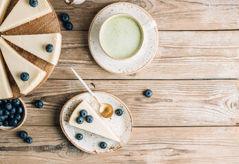 Cheesecake with blueberries on white plate. Classical New York cheesecake. Wooden background