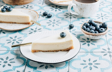Cheesecake with blueberries on white plate. Classical New York cheesecake.
