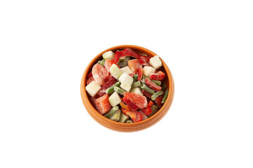 Different Frozen Vegetables in clay bowl on white background. Mexican mix. Concept - Freezing and proper defrosting of vegetables