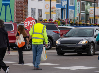 crossing guard with stop sigh in the street