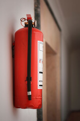 red fire extinguisher in apartment corridor